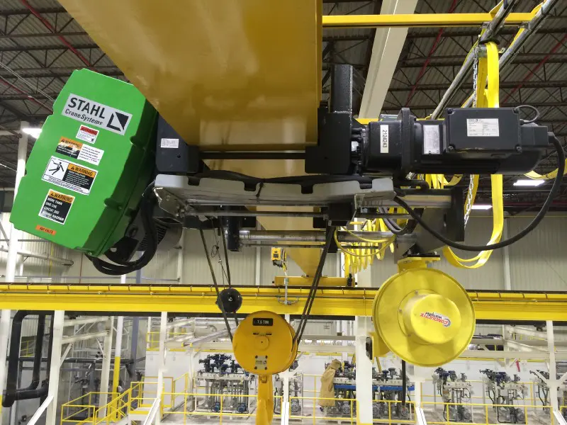 Overhead crane system in industrial facility.