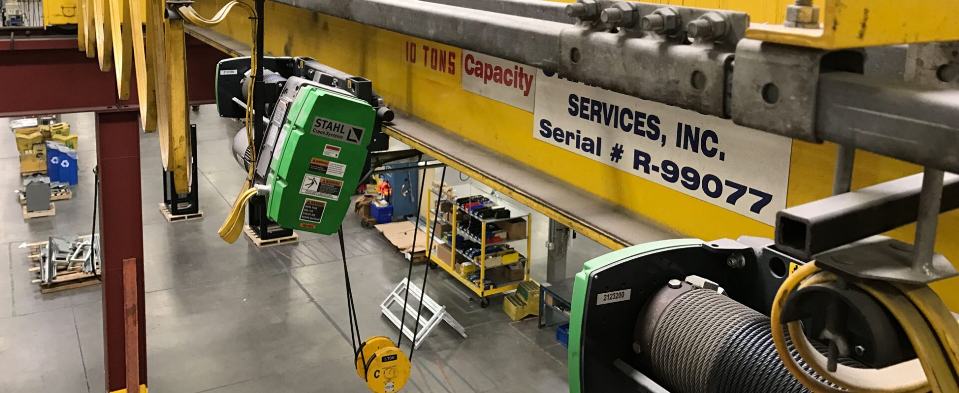 Overhead crane in industrial warehouse setting.